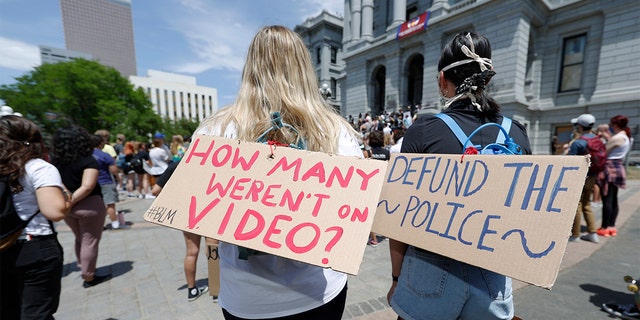 Demonstrators, with signs attached to their packs, gather outside the State Capitol in Denver, Tuesday, June 2, 2020, to protest the death of George Floyd, who died after being restrained by Minneapolis police officers on May 25. (AP Photo/David Zalubowski)