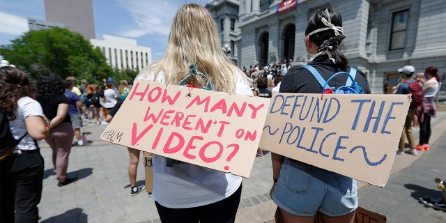 Demonstrators, with signs attached to their packs, gather outside the State Capitol in Denver, Tuesday, June 2, 2020, to protest the death of George Floyd, who died after being restrained by Minneapolis police officers on May 25. (AP Photo/David Zalubowski)