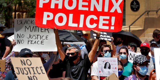 In this June 3, 2020, photo, protesters rally Wednesday, June 3, 2020, in Phoenix, demanding that the Phoenix City Council defund the Phoenix Police Department. (AP Photo/Matt York)