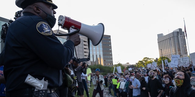 Police officers speaking to demonstrators in Detroit last May following a night of protests that saw several arrests and uses of tear gas by law enforcement. (SETH HERALD/AFP via Getty Images, File)