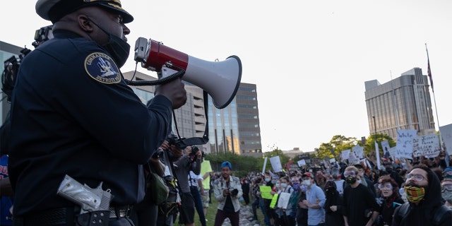 Police officers speaking to demonstrators in Detroit last May following a night of protests that saw several arrests and uses of tear gas by law enforcement. (SETH HERALD/AFP via Getty Images, File)