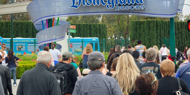 Anaheim, California, USA - April 30, 2013: A large group of people entering the Disneyland Resort in Anaheim, where Disneyland Park and Disney California Adventure Park are located.