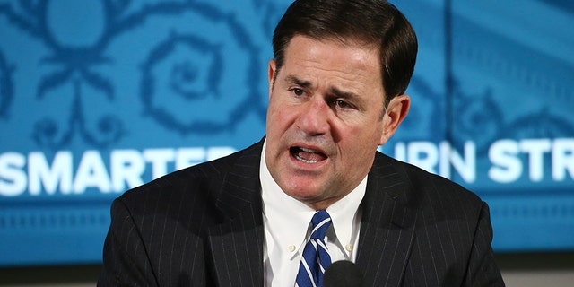 Arizona Republican Gov. Doug Ducey announces the latest coronavirus numbers and recent spike in cases during a news conference Thursday, June 11, 2020, in Phoenix. (AP Photo/Ross D. Franklin, Pool)