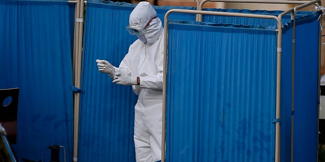 A health worker collects a sample from a man at a drive-through testing and screening facility for the coronavirus, in Islamabad, Pakistan, Saturday, June 6, 2020. (AP Photo/Anjum Naveed)