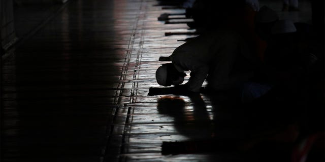 Indian Muslims offer prayers after Jama Mosque opened after lockdown in New Delhi, India, Monday, June 8, 2020. India is reopening its restaurants, shopping malls and religious places in most of its states after a more than 2-month-old lockdown even as the country continues to witness a worrying rise in new coronavirus infections. (AP Photo/Manish Swarup)