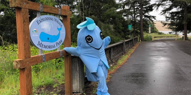 A local resident dressed up as “Flo the Whale” to highlight the new name of the park in Florence, Ore.