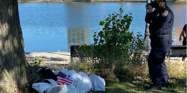 When officers and a supervisor arrived at the scene, they found “material stuffed in the shape of a human body with a rope tied around the torso and neck, laying on the ground next to a tree with an American flag lying next to it.”