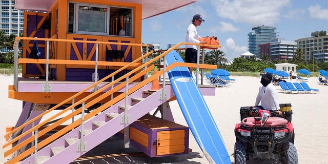 Lifeguards on duty talk as beaches reopened with restrictions to limit the spread of COVID-19 in Miami Beach, Florida, on June 10, 2020. (Reuters/Marco Bello)