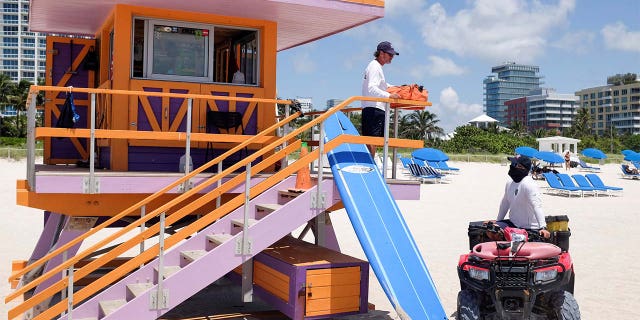Lifeguards on duty talk as beaches are reopened with restrictions to limit the spread of the coronavirus disease (COVID-19), in Miami Beach, Florida, on June 10, 2020. (REUTERS/Marco Bello)