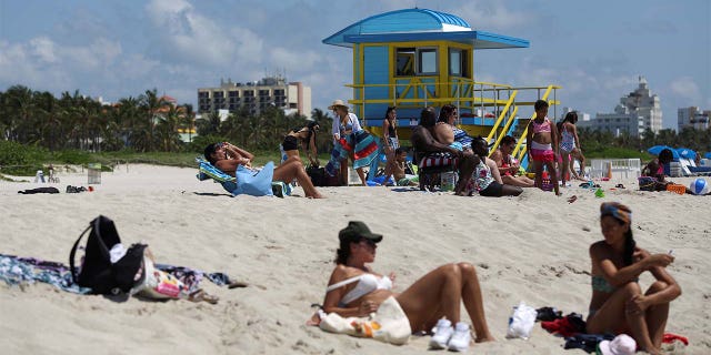 Beachgoers sunbathe as beaches are reopened with restrictions to limit the spread of the coronavirus disease (COVID-19), in Miami Beach, Florida, U.S., June 10, 2020. REUTERS/Marco Bello - RC2J6H9PQG3A