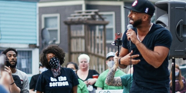 Christophe Ulysse of YWAM Kona, Hawaii speaks at a service at the site of the George Floyd memorial in Minneapolis, Minn.