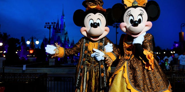 Mickey and Minnie pose with Halloween costumes during Mickey's Not-So-Scary Halloween Party at Magic Kingdom in 2018. (Gerardo Mora/Getty Images)
