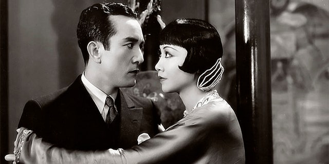 Actress Anna May Wong and Sessue Hayakawa with Harold Minjir in a scene from the movie 'Daughter of the Dragon.'