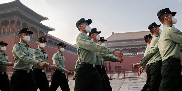 People's Liberation Army (PLA) soldiers march next to the entrance to the Forbidden City during the opening ceremony of the Chinese People's Political Consultative Conference (CPPCC) in Beijing on May 21, 2020. - China's biggest political event of the year, the National People's Congress (NPC), opens on May 22 after months of delay over coronavirus fears, with President Xi Jinping determined to project strength and control over the outbreak despite international criticism and a wounded economy. (Photo by NICOLAS ASFOURI / AFP) (Photo by NICOLAS ASFOURI/AFP via Getty Images)