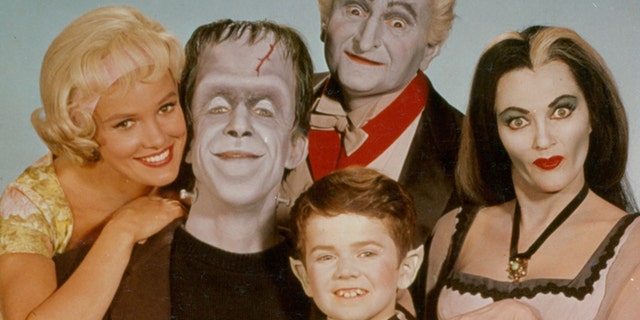 Pat Priest, Al Lewis and Butch Patrick along with Fred Gwynne and Yvonne De Carlo of the Munster family in a publicity photograph from the television series 'The Munsters,' circa 1964.?