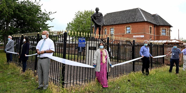 LEICESTER, UNITED KINGDOM - JUNE 13: Keith Vaz, the former Member of Parliament for Leicester West helps form a barrier around the statue of Mahatma Gandhi on June 13, 2020 in Leicester, United Kingdom. (Photo by Ross Kinnaird/Getty Images)