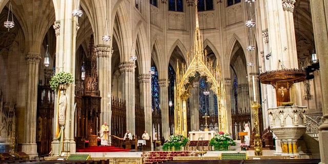 Cardinal Timothy Dolan celebrates Easter Mass amid the Coronavirus pandemic in the near-empty St. Patrick's Cathedral on April 12, 2020 in New York City. (Photo by Kena Betancur / AFP) (Photo by KENA BETANCUR/AFP via Getty Images)