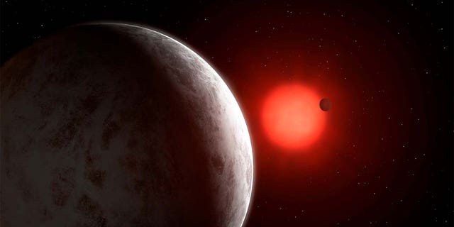 在这位艺术家的印象中，可以看到新发现的超级地球的多行星系统围绕附近的红矮星Gliese 887运转。 通过REUTERS标记Garlick /讲义。