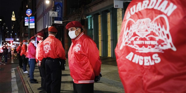 Members of the Guardian Angels, a volunteer organization of unarmed citizens which began in the late 1970's, stand guard near looted stores during a night of protests and vandalism over the death of George Floyd on June 1, 2020, in New York City. (Spencer Platt/Getty Images)