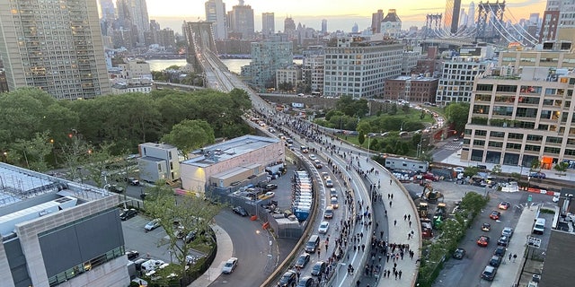 Hundreds of protestors streamed across the Brooklyn Bridge toward Manhattan on Monday night chanting 