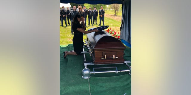 Robinson passed away in May due to his illness. Wife Danielle Robinson is seen here during his burial ceremony.