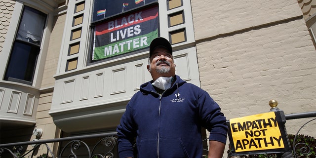 James Juanillo posing outside of his home in San Francisco on Sunday. (AP Photo/Jeff Chiu)