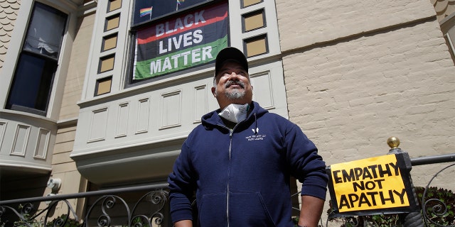 James Juanillo posing outside of his home in San Francisco on Sunday. (AP Photo/Jeff Chiu)