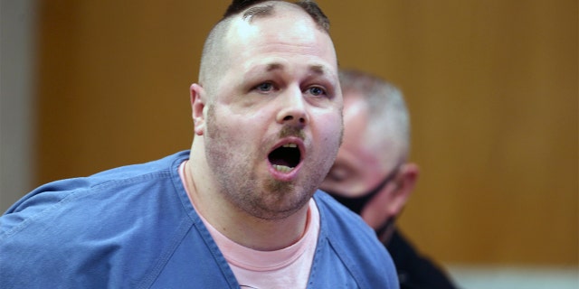 In this Tuesday, June 23, 2020 photo, Jeremy Christian reacts before being removed by deputies during his sentencing hearing in Portland, Ore. A judge has sentenced Jeremy Christian to spend the rest of his life in prison for fatally stabbing two people during his racist rant on a light-rail train in 2017. Multnomah County Circuit Judge Cheryl Albrecht sentenced Christian to two life sentences Wednesday, June 24, 2020, after listening to statements from Christian's victims or victims' relatives The Oregonian/OregonLive reported. (Dave Killen/The Oregonian via AP, Pool)