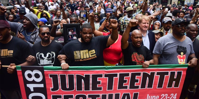 Chants for Antwon Rose Jr. fill the air on Fifth Avenue during Pittsburgh's Juneteenth Parade from Freedom Corner in the Hill District to Point State Park, Saturday, June 23, 2018. The parade served as an outlet for the crowd to protest East Pittsburgh police officer Michael Rosfeld's fatal shooting of 17-year-old Antwon Rose, a Woodland Hills High School honors student.