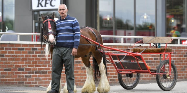 Ian Bell says that a manager of the KFC came outside after Bell pulled into the drive-thru with his horse-drawn carriage, Southwest News Service (SWNS) reports.