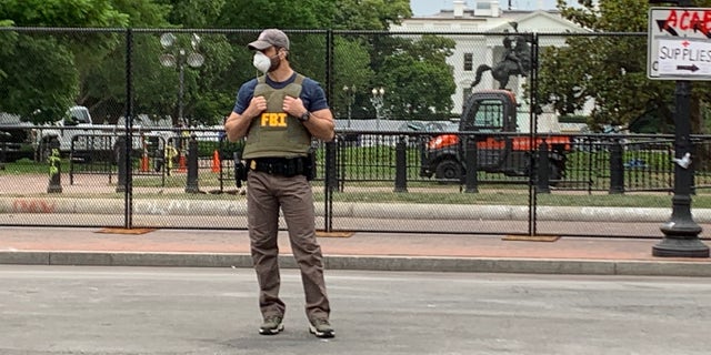 FBI agent guarding the area outside the White House after days of protests that turned violent. (Mark Meredith/FNC)