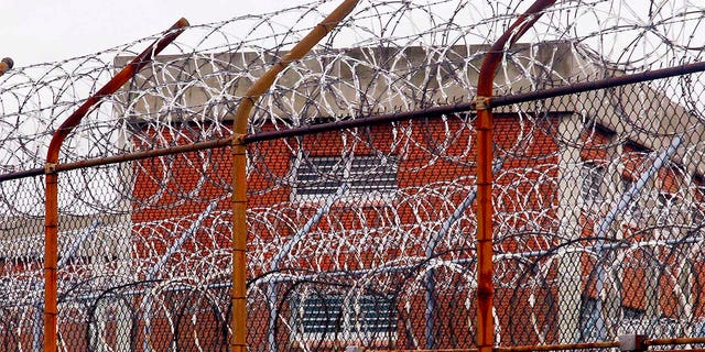 A security fence surrounds inmate housing at Rikers Island on March 16, 2011.