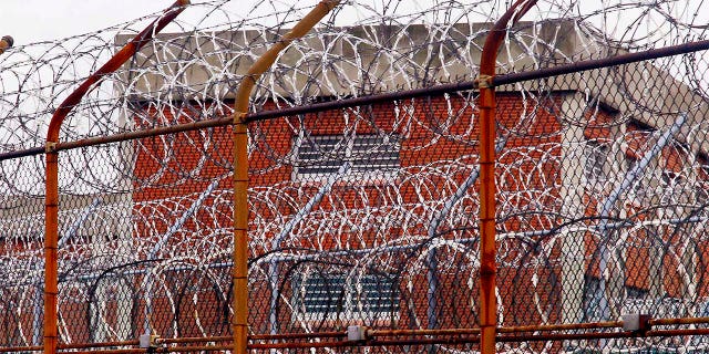 A security fence surrounds inmate housing at Rikers Island on March 16, 2011.