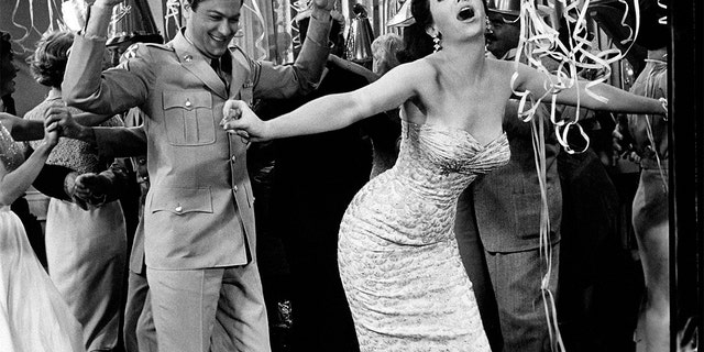 Argentine-American actress Linda Cristal, born Maria Victoria Moya Burges, goes wild at a party with American actor Tony Curtis, born Bernard Schwartz, in a scene from the movie, 'The Perfect Furlough,' by American director Blake Edwards. 1959. (Photo by Mondadori via Getty Images)