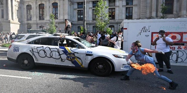 This photo from federal prosecutors shows protesters damaging a Philadelphia police car.