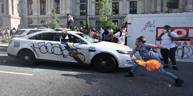 This photo from federal prosecutors shows protesters damaging a Philadelphia police car.