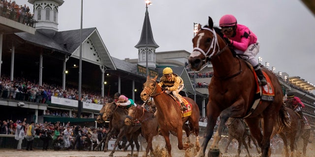 Luis Saez rides Maximum Security, right, across the finish line first against Flavien Prat on Country House during the 145th running of the Kentucky Derby at Churchill Downs in Louisville, Ky., May 4, 2019. (Associated Press)<br>
