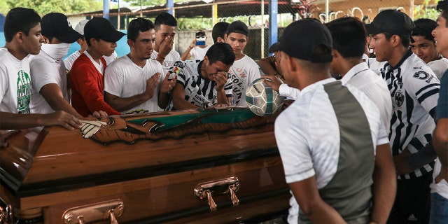 Alexander Martinez's family and friends mourn during his funeral in Acatlan de Perez Figueroa, Mexico, Thursday, June 11, 2020. Hundreds of residents of this town in southern Mexico bid farewell amid anger and tears to Alexander Martinez, a 16-year-old Mexican-American boy shot dead by local police.