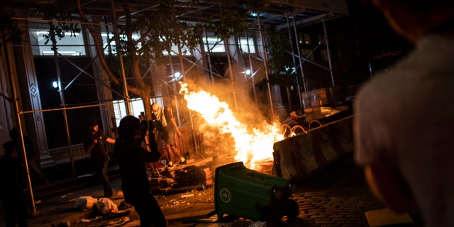 Protesters start fires along the SoHo shopping district on Sunday, May 31, 2020, in New York. Protests were held throughout the city over the death of George Floyd, a black man in police custody in Minneapolis who died after being restrained by police officers on Memorial Day. (AP Photo/Wong Maye-E)