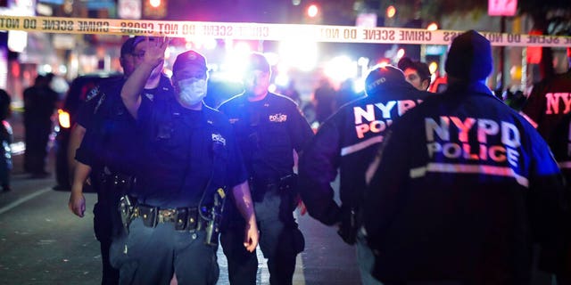 New York City police officers work a scene early June 4, in the Brooklyn borough of New York.(AP Photo/Frank Franklin II)