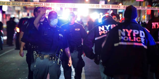 New York City police officers work a scene early June 4, in the Brooklyn borough of New York. The police department says a police officer has been shot in Brooklyn. The shooting happened late Wednesday, nearly four hours after an 8 p.m. curfew went into effect intended to quell unrest over the death of George Floyd in Minnesota. (AP Photo/Frank Franklin II)