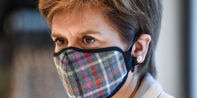 First Minister of Scotland Nicola Sturgeon wears a Tartan face mask as she visits New Look at Ford Kinaird Retail Park on June 26, 2020, in Edinburgh, Scotland. 