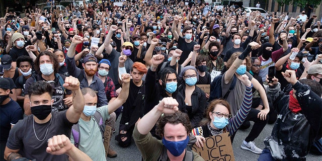 Protesters raise their fist in front of Gracie Mansion, the official residence of the New York mayor, during a protest June 2, in New York over the death of George Floyd, who died May 25 after he was pinned at the neck by a Minneapolis police officer. (AP Photo/Yuki Iwamura)