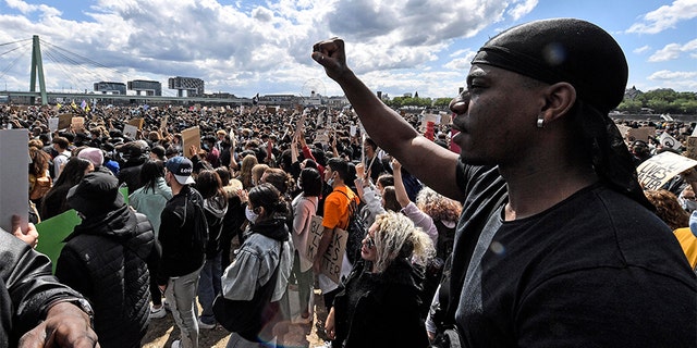 Thousands of people demonstrate in Cologne, Germany, Saturday June 6, 2020, to protest against racism and the recent killing of George Floyd by police officers in Minneapolis, USA. His death has led to Black Lives Matter protests in many countries and across the US. A US police officer has been charged with the death of George Floyd. (AP Photo/Martin Meissner)