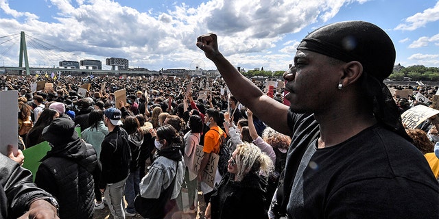 Thousands of people demonstrate in Cologne, Germany, Saturday June 6, 2020, to protest against racism and the recent killing of George Floyd by police officers in Minneapolis, USA. His death has led to Black Lives Matter protests in many countries and across the US. A US police officer has been charged with the death of George Floyd. (AP Photo/Martin Meissner)