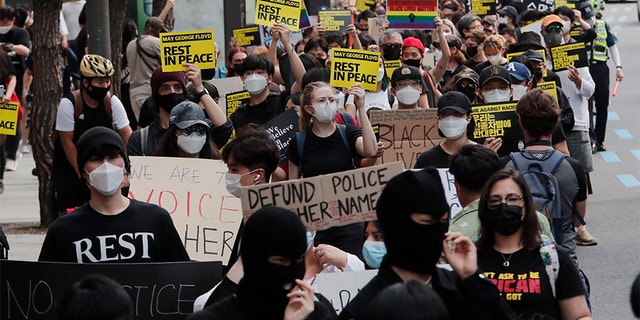 People march to protest during a solidarity rally for the death of George Floyd in Seoul, South Korea, Saturday, June 6, 2020. Floyd died after being restrained by Minneapolis police officers on May 25.(AP Photo/Ahn Young-joon)