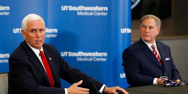 Vice President Mike Pence makes remarks as Texas Gov. Greg Abbott looks on during a news conference after Pence met with Abbott and members of his healthcare team regarding COVID-19. (AP Photo/Tony Gutierrez)