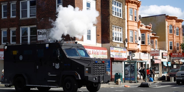 Police deploy tear gas to disperse a crowd during a protest Sunday, May 31, 2020, in Philadelphia over the death of George Floyd.