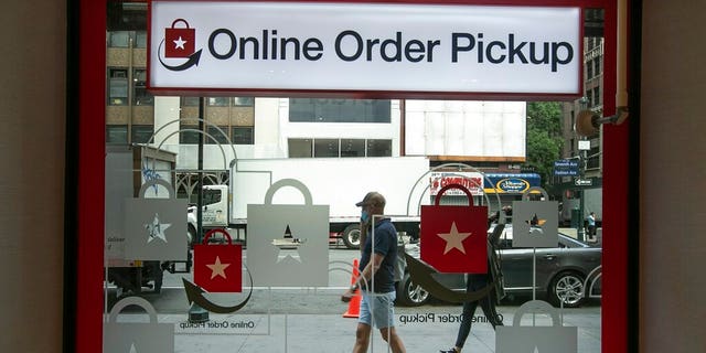 Pedestrians pass the online order pickup area at the Macy's Herald Square location Friday, June 19, 2020, in New York. New York City hits a key point Monday in trying to rebound from the nation’s deadliest coronavirus outbreak. (AP Photo/Frank Franklin II)