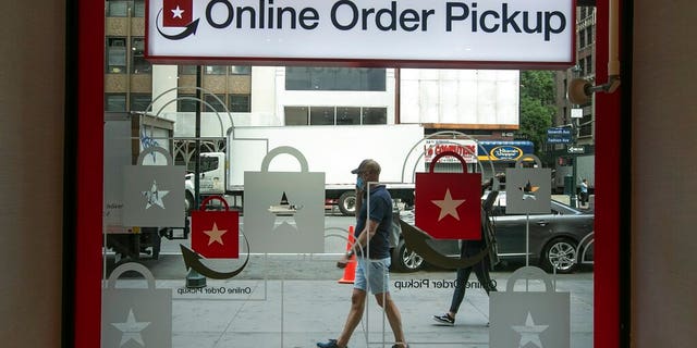 Pedestrians pass the online order pickup area at the Macy's Herald Square location Friday, June 19, 2020, in New York. New York City hits a key point Monday in trying to rebound from the nation’s deadliest coronavirus outbreak. (AP Photo/Frank Franklin II)